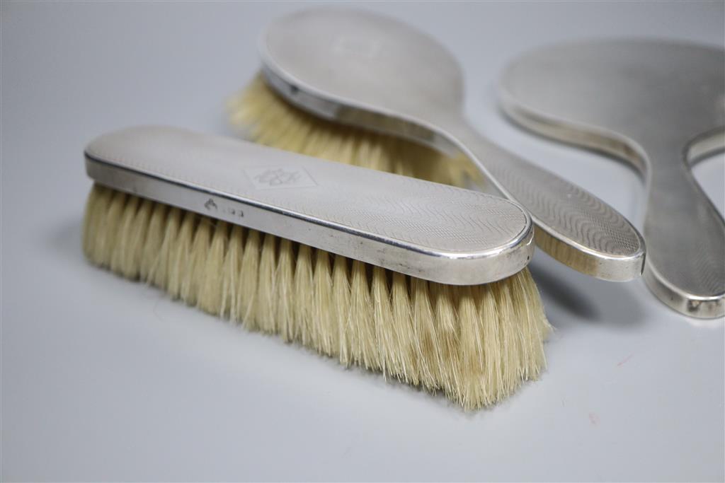 A 1920s engine turned silver mounted four piece mirror and brush set by Elkington & Co, Birmingham, 1925.